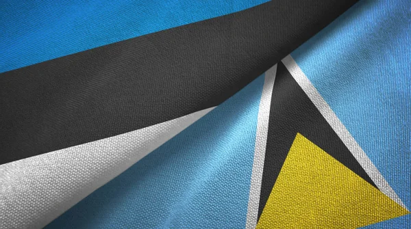 Estónia e Santa Lúcia duas bandeiras de pano têxtil, textura de tecido — Fotografia de Stock