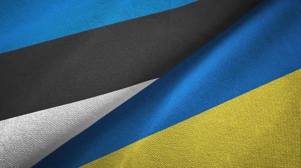 Észtország és Ukrajna két zászló textil ruhával, szövet textúra — Stock Fotó