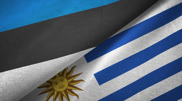 Estland och Uruguay två flaggor textil trasa, tyg textur — Stockfoto