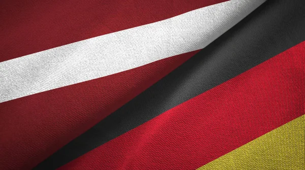 Lettonia e Germania due bandiere tessuto, tessitura tessuto — Foto Stock