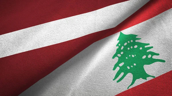 ラトビアとレバノン2つの旗織物布、生地の質感 — ストック写真