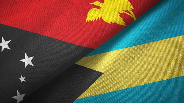 Papúa Nueva Guinea y Bahamas dos banderas tela textil, textura de la tela — Foto de Stock