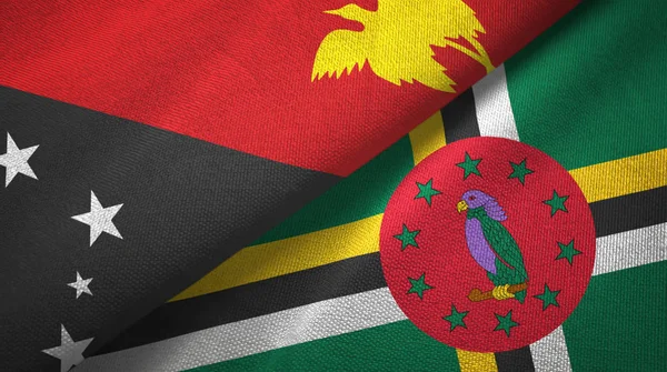 Papouasie-Nouvelle-Guinée et la Dominique deux drapeaux tissu textile, texture du tissu — Photo