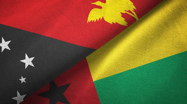 Papua Nuova Guinea e Guinea-Bissau due bandiere tessuto, tessitura del tessuto — Foto Stock