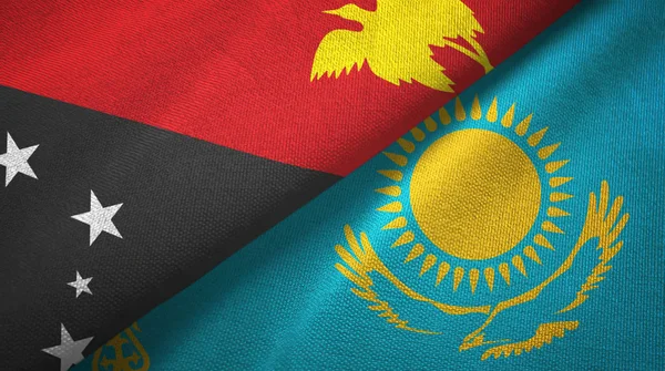 Papúa Nueva Guinea y Kazajstán dos banderas tela textil, textura de la tela — Foto de Stock