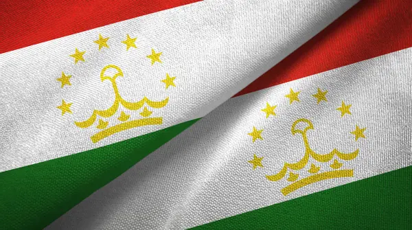 Таджикистан два флага текстильная ткань, текстура ткани — стоковое фото
