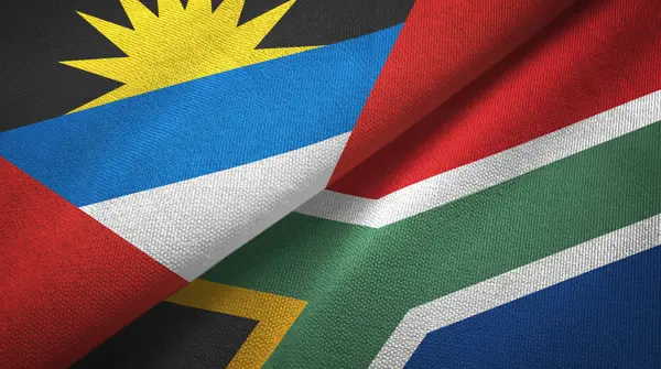 Antigua und barbuda und südafrika zwei flaggen textilstoff, textur — Stockfoto