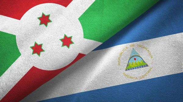 Burundi en Nicaragua twee vlaggen textiel doek, weefsel textuur — Stockfoto