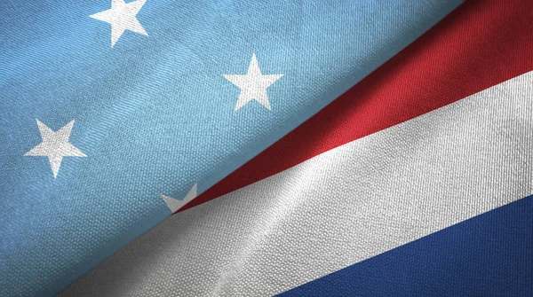 Micronesia e Paesi Bassi due bandiere tessuto, tessitura tessuto — Foto Stock