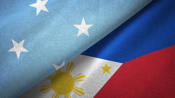 Micronesia en Filippijnen twee vlaggen textiel doek, weefsel textuur — Stockfoto