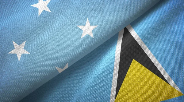 Micronesia en Saint Lucia twee vlaggen textiel doek, weefsel textuur — Stockfoto
