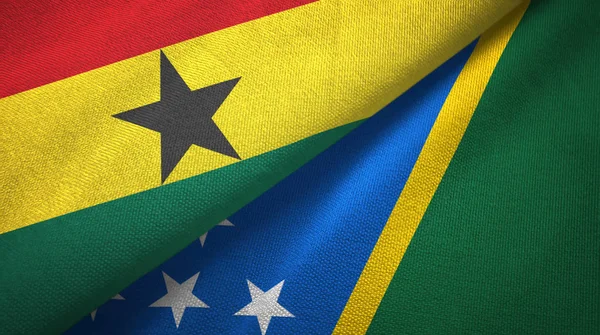 Ghana och Salomonöarna två flaggor textil tyg, tyg konsistens — Stockfoto
