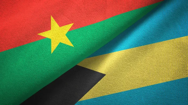 Burkina Faso y Bahamas dos banderas tela textil, textura de la tela —  Fotos de Stock