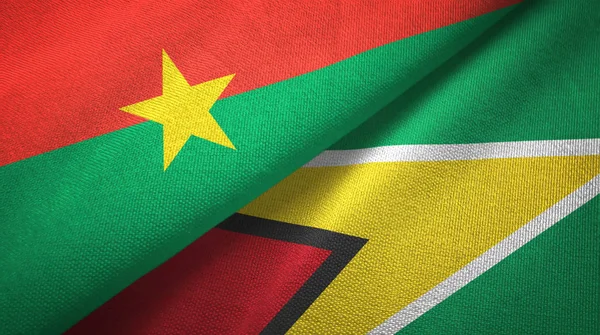 Burkina Faso och Guyana två flaggor textil trasa, tyg konsistens — Stockfoto