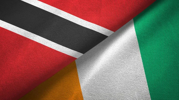 Trinidad und Tobago und Cote Divoire Elfenbeinküste zwei Flaggen Textil — Stockfoto