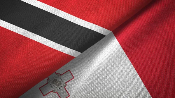 Trinidad en Tobago en Malta twee vlaggen textiel doek, weefsel textuur — Stockfoto