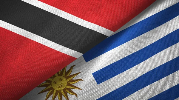 Trinidad y Tobago y Uruguay dos banderas de tela textil, textura de tela —  Fotos de Stock