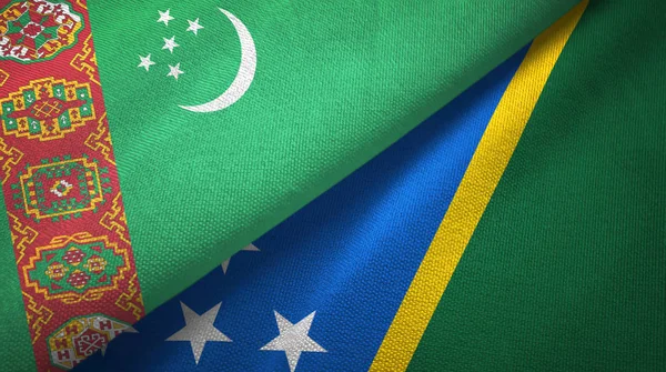 Turkmenistan and Solomon Islands two flags textile cloth, fabric texture