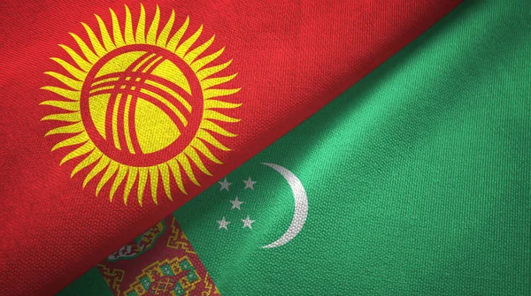 Kirghizistan e Turkmenistan due bandiere tessuto, tessitura del tessuto — Foto Stock