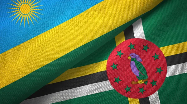 Ruanda y Dominica dos banderas tela textil, textura de la tela — Foto de Stock