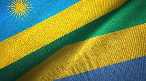 Ruanda und Gabon zwei Flaggen Textiltuch, Textilstruktur — Stockfoto