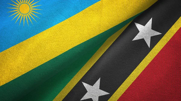 Rwanda en Saint Kitts en Nevis twee vlaggen textiel doek, stof textuur — Stockfoto