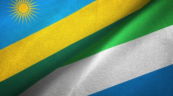Ruanda y Sierra Leona dos banderas tela textil, textura de la tela — Foto de Stock
