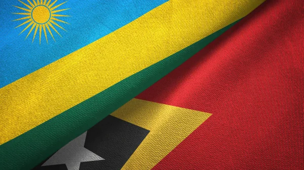 Ruanda y Timor Oriental Timor Oriental dos banderas tela textil, textura de la tela —  Fotos de Stock