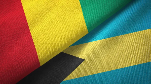 Guinea e Bahamas due bandiere tessuto, tessitura tessuto — Foto Stock