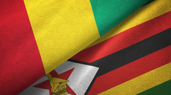 Guinea e Zimbabwe due bandiere tessuto, tessitura tessuto — Foto Stock