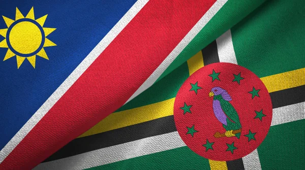 Namibia y Dominica dos banderas tela textil, textura de la tela — Foto de Stock