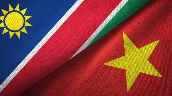 Namibia y Vietnam dos banderas tela textil, textura de la tela — Foto de Stock