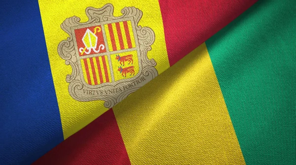 Andorra och Guinea Two flaggor textil tyg, tyg konsistens — Stockfoto