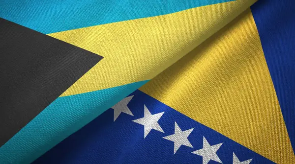 Bahamas y Bosnia y Herzegovina dos banderas tela textil, textura de la tela — Foto de Stock