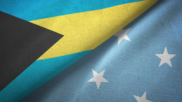 Bahama-szigetek és a Mikronézia két zászló textil ruhával, szövet textúra — Stock Fotó