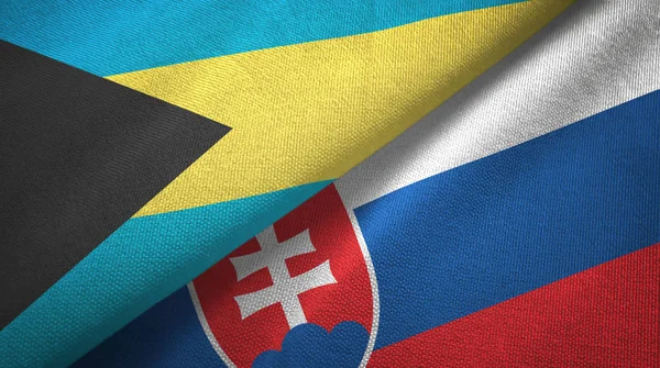 Багамські острови і Словаччина два прапори текстильна тканина, текстура тканини — стокове фото