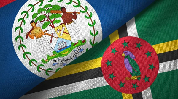 Belize und Dominica zwei Flaggen Textilstoff, Textur — Stockfoto