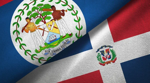 Belize e República Dominicana duas bandeiras de pano têxtil, textura de tecido — Fotografia de Stock