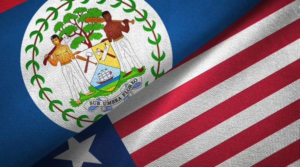 Belize i Liberia dwie flagi tkanina tekstylna, tekstura tkaniny — Zdjęcie stockowe