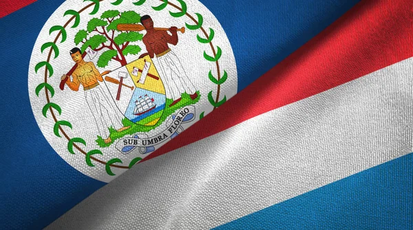 Belize i Luksemburg dwie flagi tkanina tekstylna, tekstura tkaniny — Zdjęcie stockowe