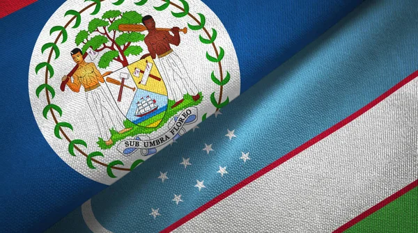 Belize e Uzbequistão duas bandeiras de pano têxtil, textura de tecido — Fotografia de Stock