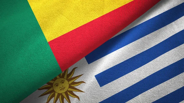Бенин и Уругвай два флага текстильная ткань, текстура ткани — стоковое фото