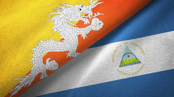 Bhutan a Nikaragua dvě vlajky textilní tkaniny, textura textilií — Stock fotografie