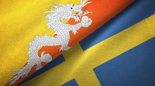 Bután y Suecia dos banderas tela textil, textura de la tela —  Fotos de Stock
