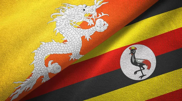 Bhutan en Oeganda twee vlaggen textiel doek, weefsel textuur — Stockfoto