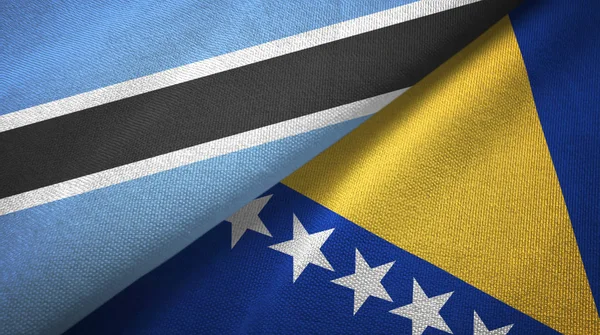 Botswana y Bosnia y Herzegovina dos banderas tela textil, textura de la tela — Foto de Stock