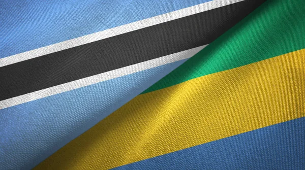 Botswana und Gabon zwei Flaggen Textiltuch, Textur — Stockfoto