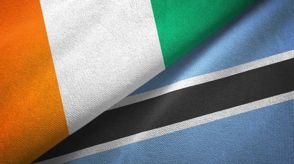 Cote dIvoire e Botswana due bandiere tessuto, tessitura del tessuto — Foto Stock