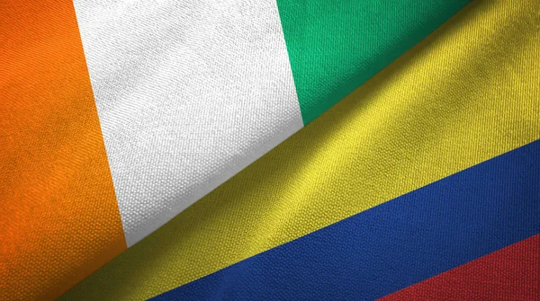 Côte d'Ivoire et Colombie deux drapeaux tissu textile, texture du tissu — Photo
