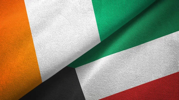 Costa do Marfim e Kuwait duas bandeiras de pano têxtil, textura de tecido — Fotografia de Stock